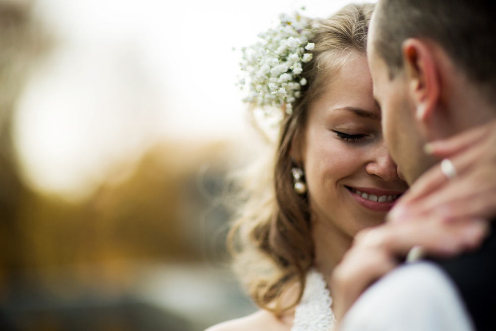beautiful couple enjoying embrace of each other and tenderly smiling